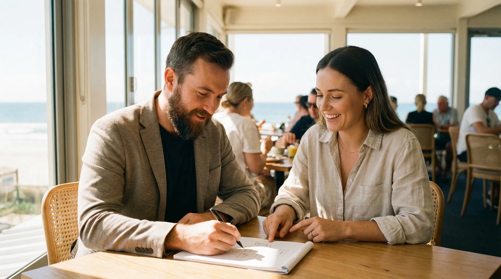 IT consultant discussing strategy with a business owner in a Gold Coast cafe