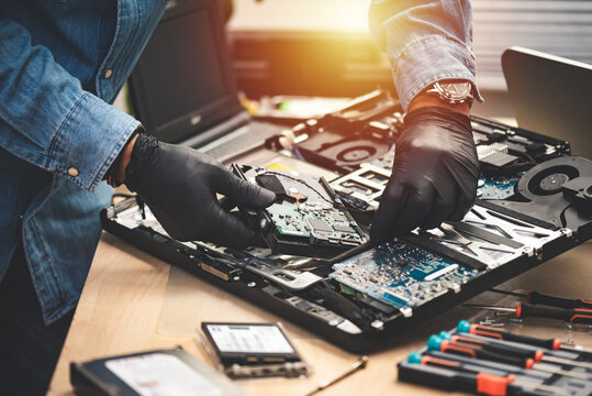 Computer repair technician diagnosing a laptop in a Gold Coast workshop