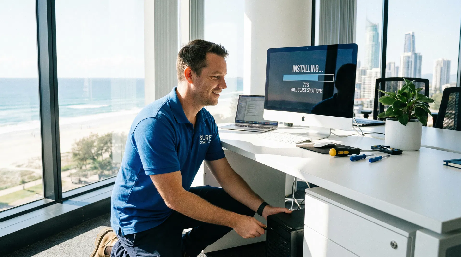 Professional IT technician installing software on a desktop computer in a Gold Coast office
